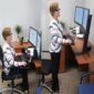 Woman Sitting and Standing at a height adjustable desk