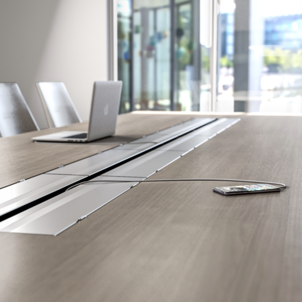 Charging a phone in a conference table with power outlets