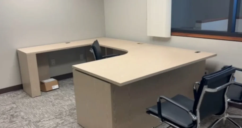 A sit-stand guest office built to the goals list above, keeping the existing casegoods.