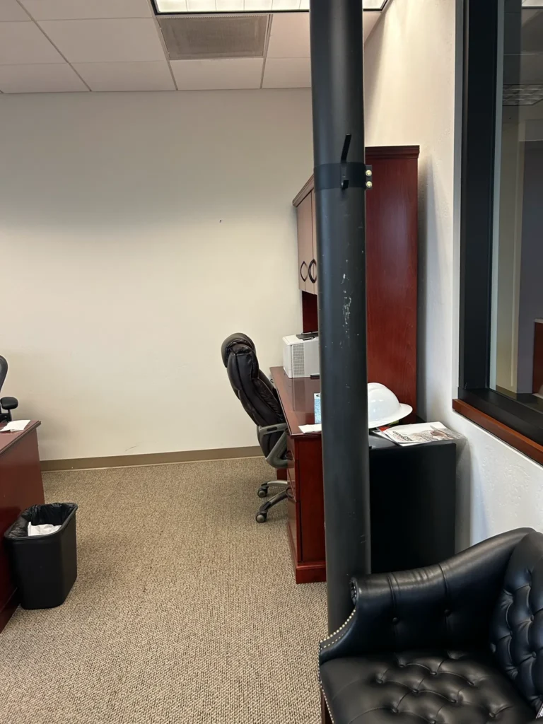 BEFORE- A pole was very visible in front of the glass that was going to be a glassboard. We covered this pole with drywall. Total transformation.