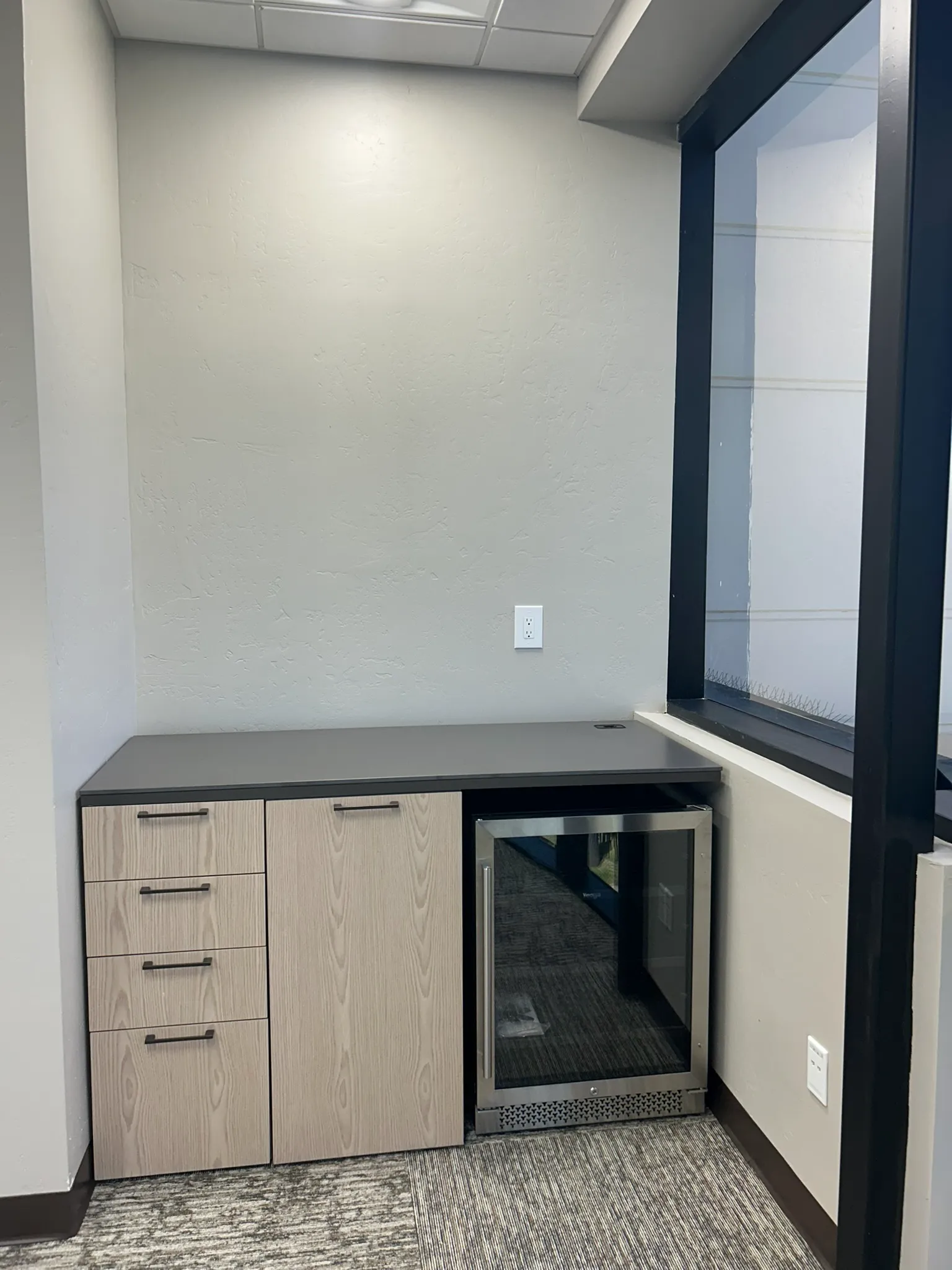 Took a space that wasn't being used and created a beverage coffee station. This was furniture made to look like Millwork. Cost savings and flexibility to move when the lease expires.