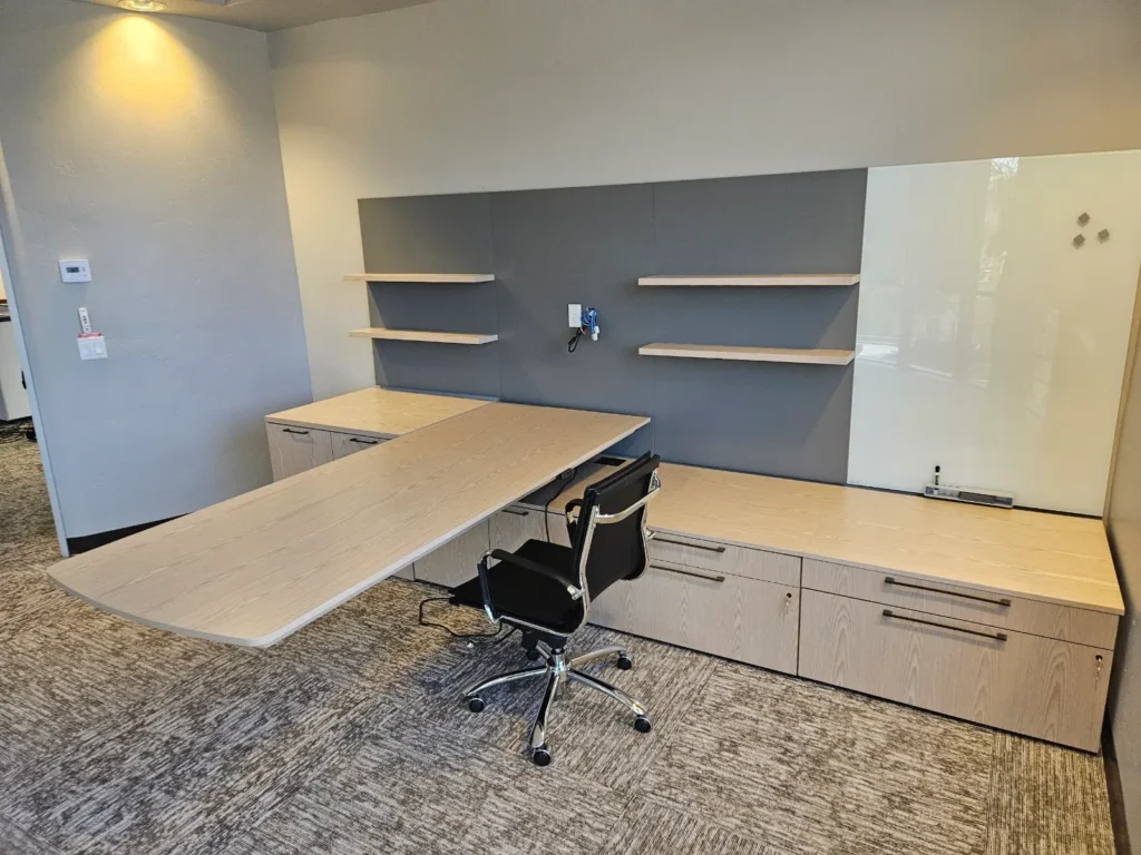 Prior to mounting the new monitor. They can now fit five of these chairs around the desk for a huddle.
